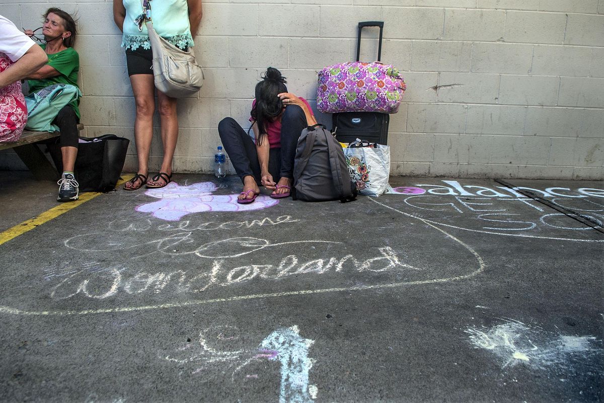 A  group gathers outside Hope House, an overnight shelter for women in Spokane, on Tuesday, July 17, 2018. (Kathy Plonka / The Spokesman-Review)