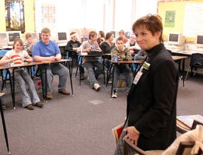 
East Valley School District    interim superintendent Debra Howard reads to a language arts class last week. An improving budget has allowed the district to restore some programs.
 (J. Bart Rayniak / The Spokesman-Review)