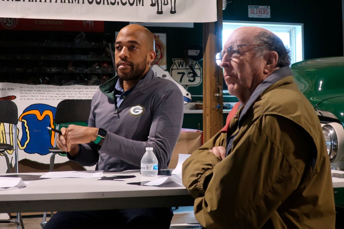 Democratic U.S. Senate candidate Mandela Barnes, left, and Maribel, Wisconsin, farmer Michael Slattery listen to a discussion about issues facing rural Wisconsin during a stop on the candidate