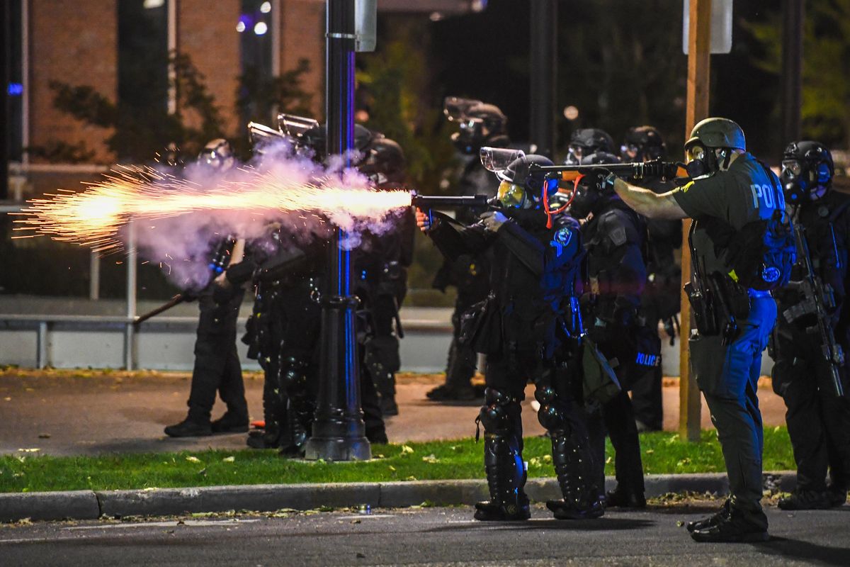 Spokane Police fires upon advancing protesters on Spokane Falls Boulevard after warning them to get back, Sunday, May 31, 2020. (Dan Pelle / The Spokesman-Review)