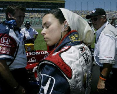 
Danica Patrick removes her safety gear after taking the pole position for the Argent Mortgage Indy 300. 
 (Associated Press / The Spokesman-Review)