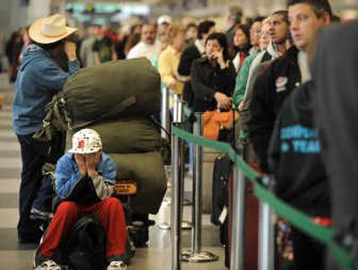 
Passengers wait in line Wednesday at O'Hare International Airport in Chicago. American Airlines canceled more than 1,000 flights Wednesday  as it spent a second straight day inspecting the wiring on many of its jets. Associated Press photos
 (Associated Press photos / The Spokesman-Review)