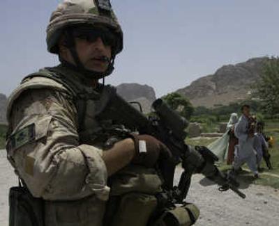 
A Canadian soldier stands guard as Afghans pass by in Kandahar province south of Kabul earlier this week.Associated Press
 (Associated Press / The Spokesman-Review)