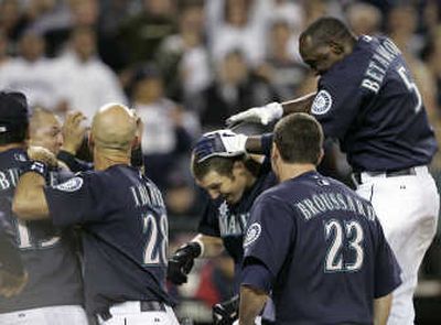 
Seattle's Richie Sexson, center, is mobbed after homering in the bottom of the ninth. Associated Press
 (Associated Press / The Spokesman-Review)