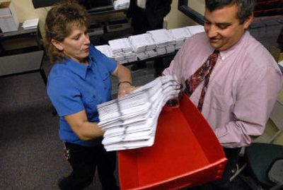 
Operations coordinator Kit Anderson and assistant elections manager Mike McLaughlin prepare  a batch of primary-election ballots in September  at the Spokane County Elections Office. 
 (Dan Pelle / The Spokesman-Review)