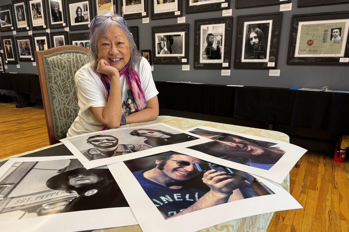 Pang poses in front of her photos for her “The Lost Weekend: The Photography of May Pang” exhibit, which is coming to the Marmot Art Space this weekend.  (Courtesy of Scott Segelbaum)