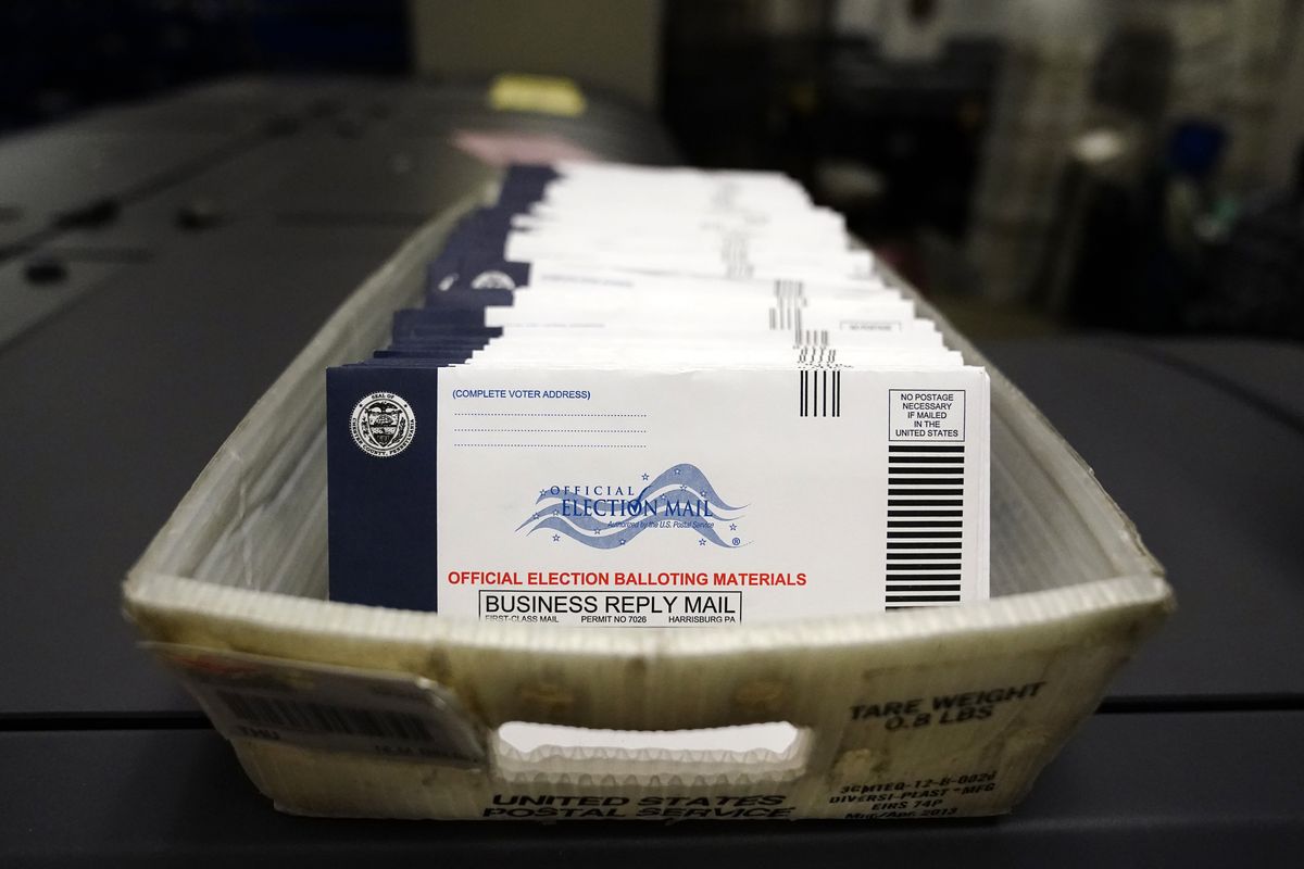 In this Oct. 23, 2020 photo mail-in ballots for the 2020 General Election in the United States are seen before being sorted at the Chester County Voter Services office in West Chester, Pa. A new study finds the expansion of mail voting did not benefit Democrats or increase turnout.  (Matt Slocum)
