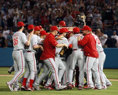 Where’s Roy? Teammates swarm Halladay after perfect game. (Associated Press)