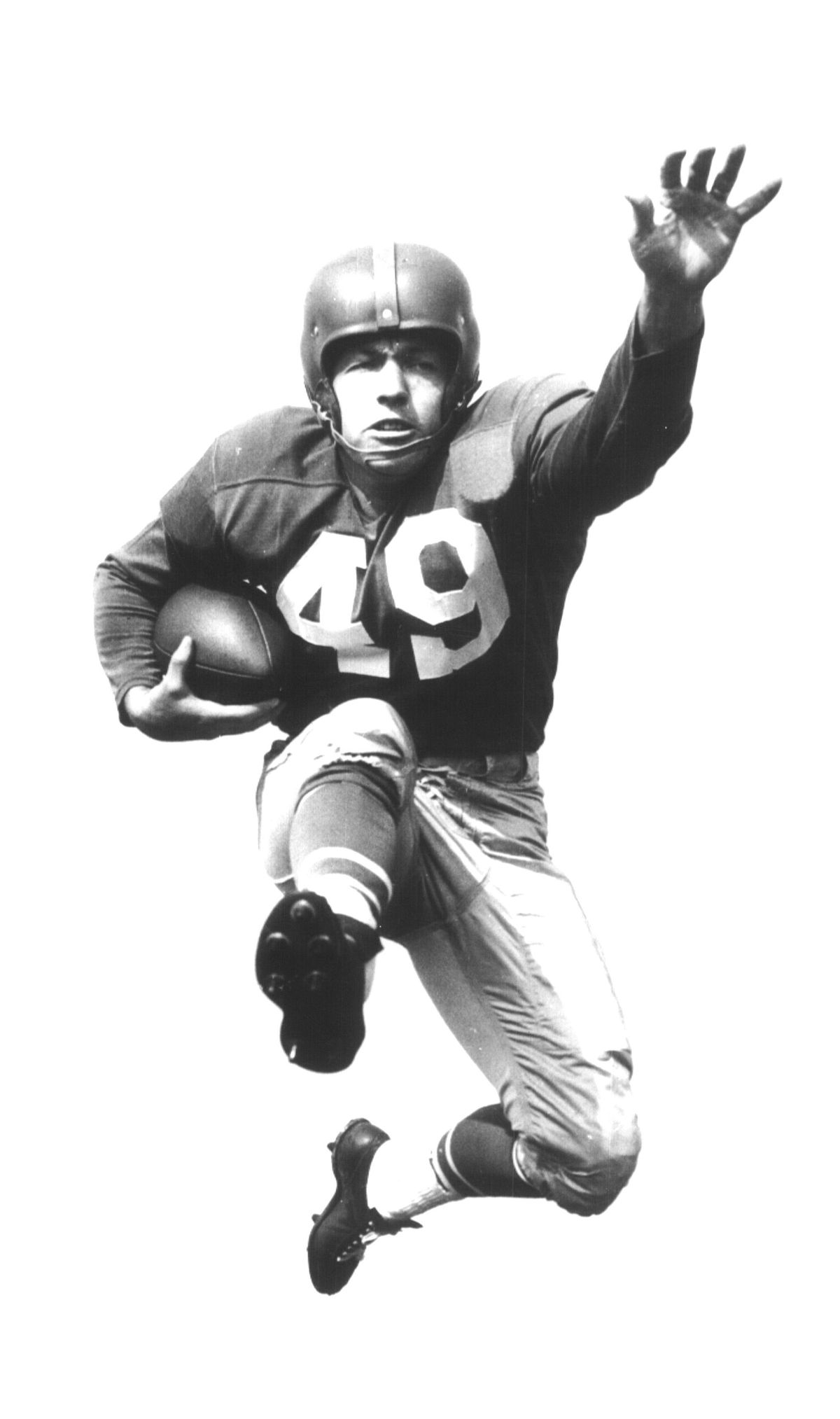 Jerry Williams Leaps Forward With Ball in Hand and Arm Out. Sports. Football. (Spokesman Archive)