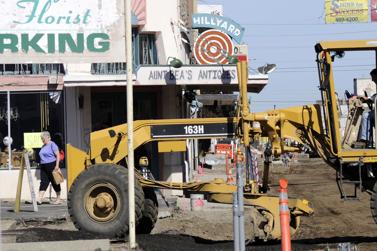 A road grader builds a ramp on Olympic Street on Friday as workers renovate Market Street in Hillyard  in Spokane. (Dan Pelle / The Spokesman-Review)