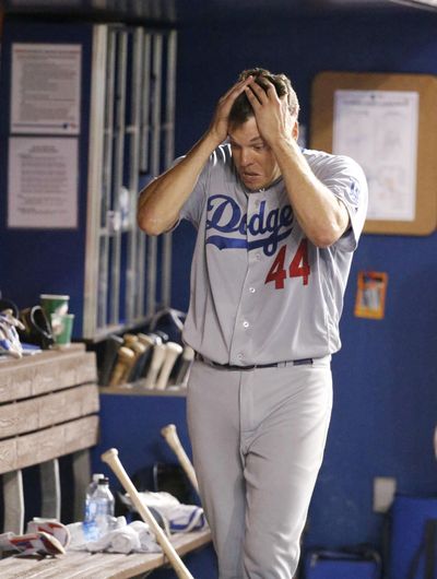 Los Angeles Dodgers starting pitcher Rich Hill runs his hands through his hair after being pulled after pitching seven perfect innings. (Wilfredo Lee / Associated Press)