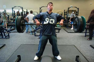
Rogers High School student Brad Norred,  15, lifts in the school's new weight room Wednesday. The gym is part of a $66.8 million makeover. 
 (Photos by DAN PELLE / The Spokesman-Review)