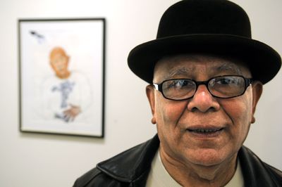 Prominent artist Ruben Trejo, who died Sunday in Spokane,  is pictured in January  2008 with a self-portrait. (Dan Pelle / The Spokesman-Review)