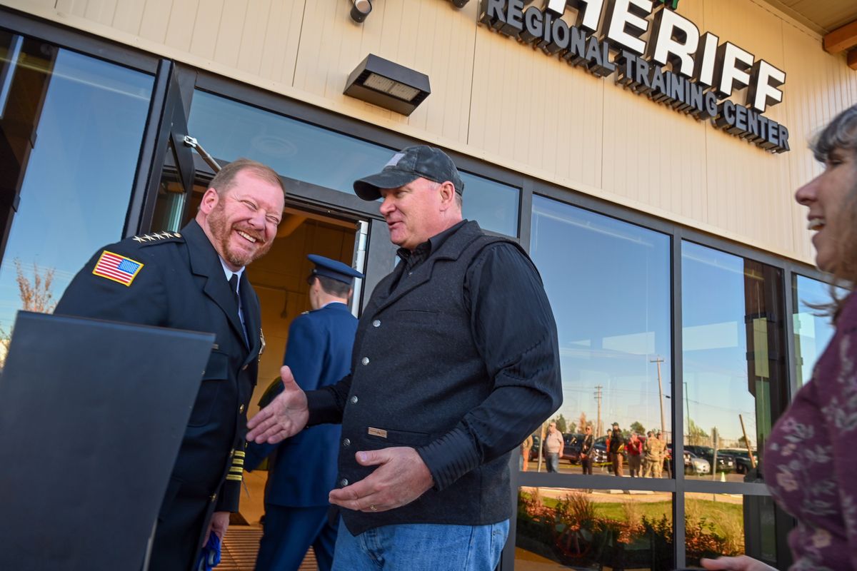 Current Spokane County Sheriff John Nowels, left, and former sheriff Ozzie Knezovich, right, share a laugh after cutting the ribbon on the Spokane County Sheriff Regional Training Center Thursday, Oct 19, 2023, on the State Highway 902 on the West Plains of Spokane, Washington. (Jesse Tinsley/THE SPOKESMAN-REVIEW)