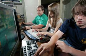 
John Idler and his children, Elizabeth, 13, and Josh, 14, play video games together last week at their Moorestown, N.J., home.
 (Associated Press / The Spokesman-Review)