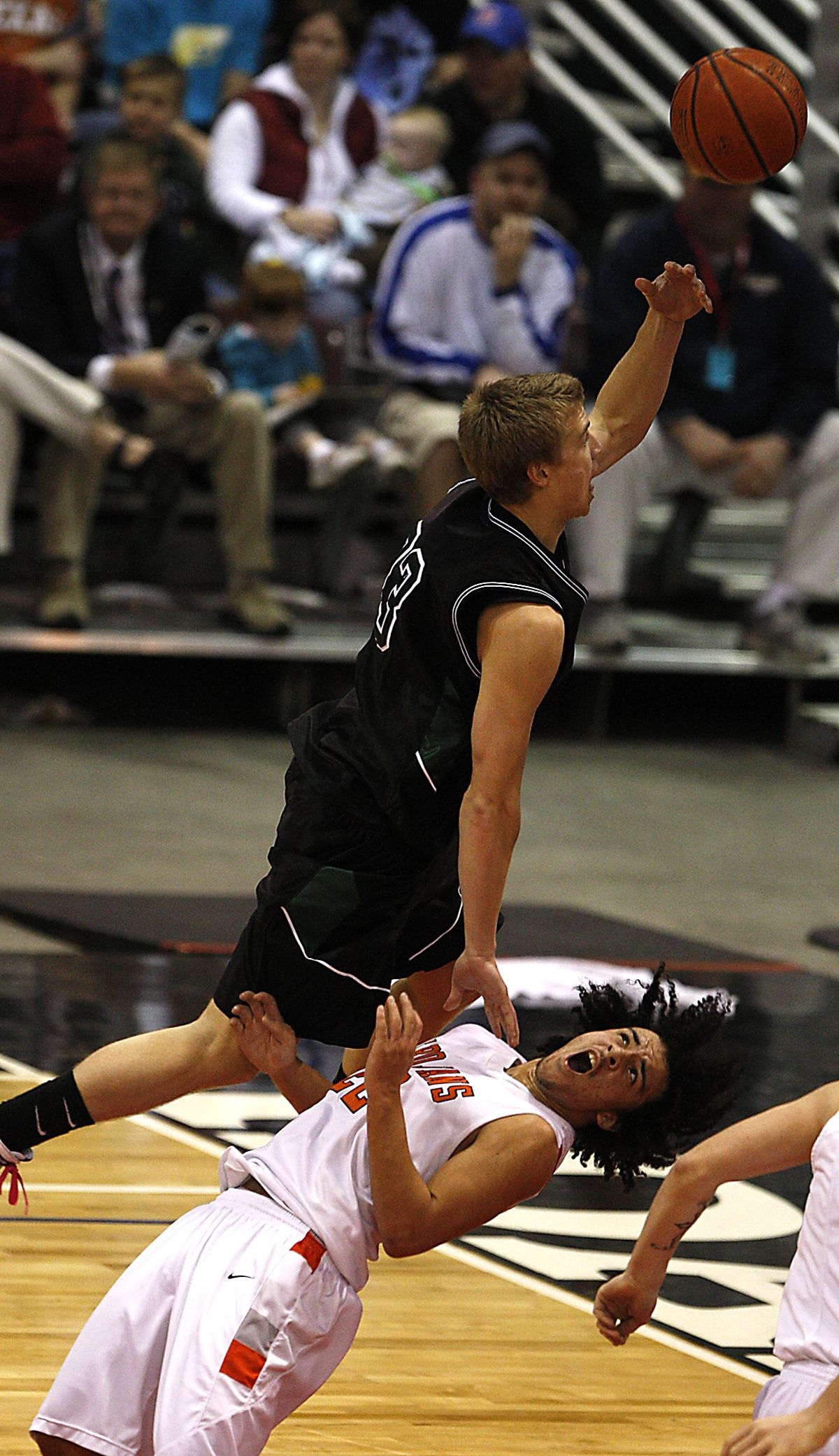 Post Falls’ Marcus Colbert takes a charge from Eagle’s Cory Cramer. (Associated Press)