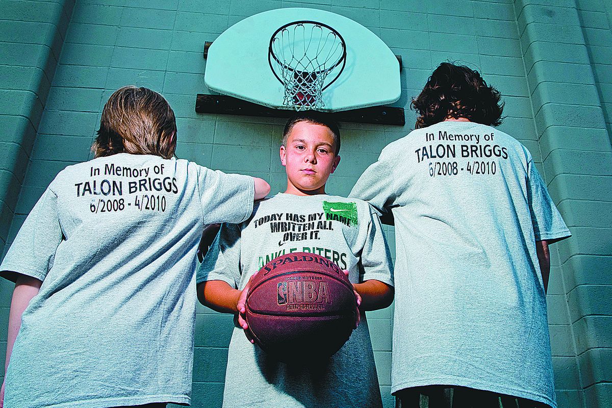 Devin Perez, 12, is playing in Hoopfest this weekend in honor of his nephew, Talon Briggs, who died earlier this year.  The team, including Gabe Ries, 12, left, and Alex Patterson,  12, will  wear  shirts that honor Talon.  (Colin Mulvany)