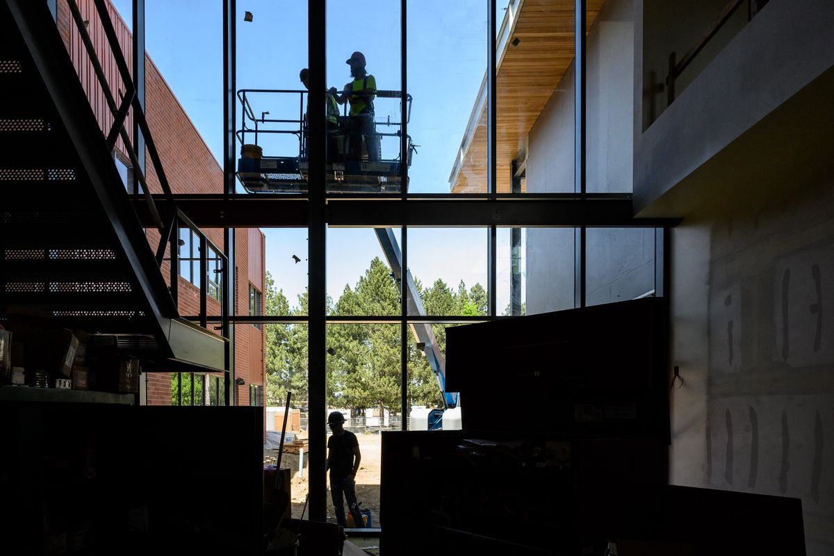 Construction workers seal windows on the north side of the new Linwood Elementary School at 906 West Weile Ave. The school design features large windows to help brighten up hallways and common spaces. The building is nearing completion and will open for students in the 2019-2020 school year. The school features 36 classrooms and cost $2.6 million to construct. (Colin Mulvany / The Spokesman-Review)
