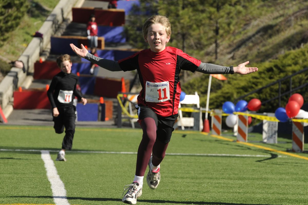 Justin Janke, 11, celebrates his finish at the 2010 America's Kids Run, April 24, in Spokane, Wa.  After 25 years the event held its last race on Saturday at Joe Albi Stadium. (Dan Pelle / The Spokesman-Review)