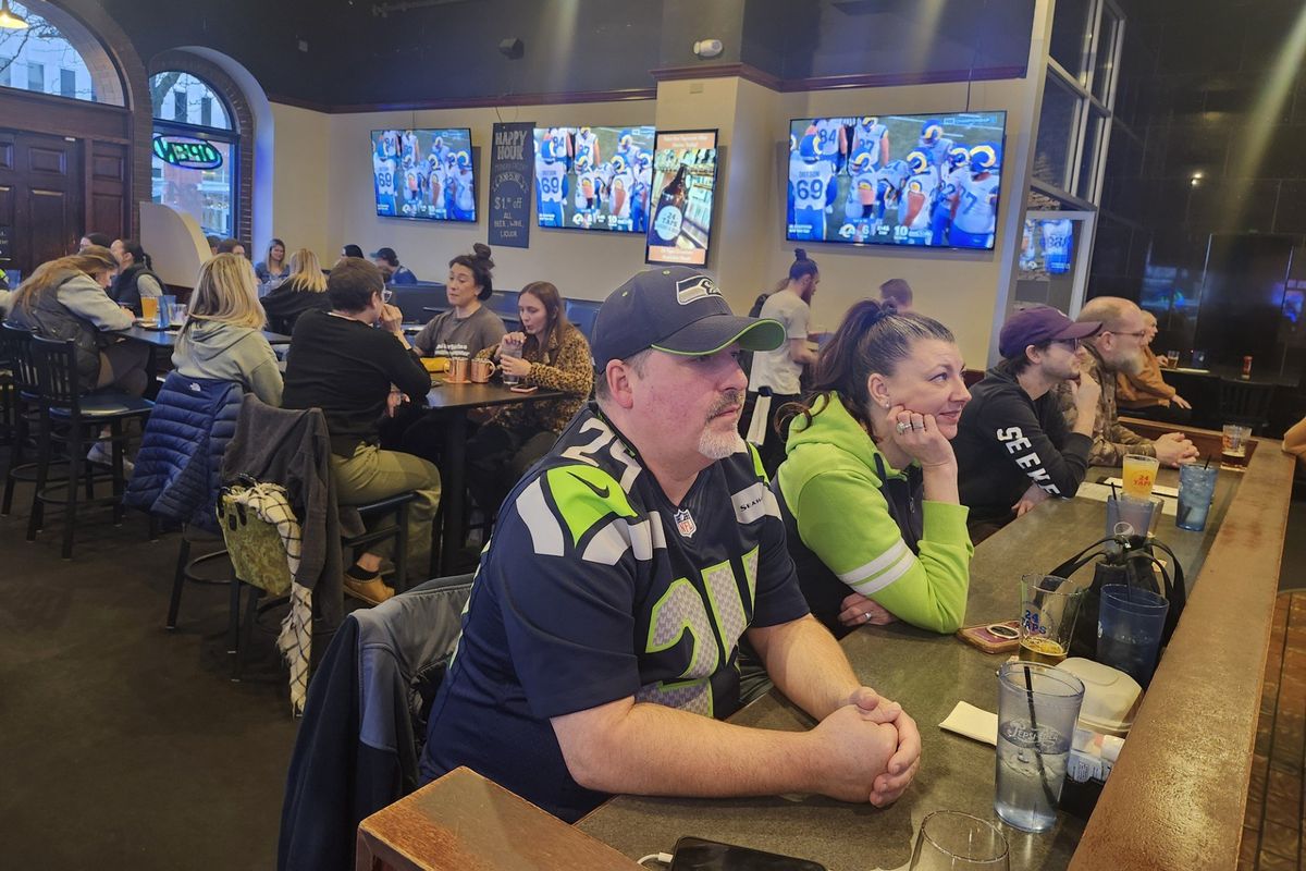 Cole Hameron and Constance Valandra watch the Seahawks’ NFC championship game against the Los Angeles Rams at 24 Taps Burgers & Brews on Sunday in Spokane.  (Amanda Sullender / The Spokesman-Review)