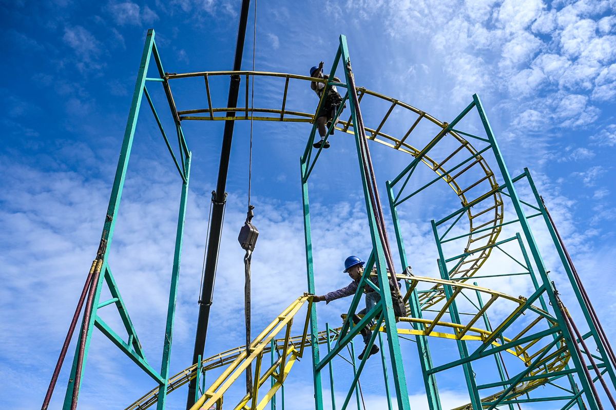 Workers construct the traveling Zillereator steel roller coaster ride, Thursday, Sept. 7, 2023, at the Spokane County Interstate Fair. The fair started that Friday, Sept. 8, and ran through Sunday, Sept. 17.  (DAN PELLE/THE SPOKESMAN-REVIEW)
