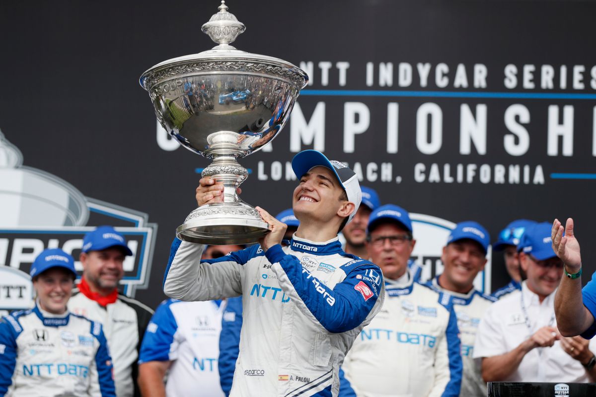 FILE -NTT IndyCar Series winner Alex Palou, center, celebrates with the trophy after taking 4th place in an IndyCar auto race at the Grand Prix of Long Beach, Sunday, Sept. 26, 2021, in Long Beach, Calif. The stars of IndyCar crowded into Indianapolis Motor Speedway to celebrate an upcoming season of opportunity for America