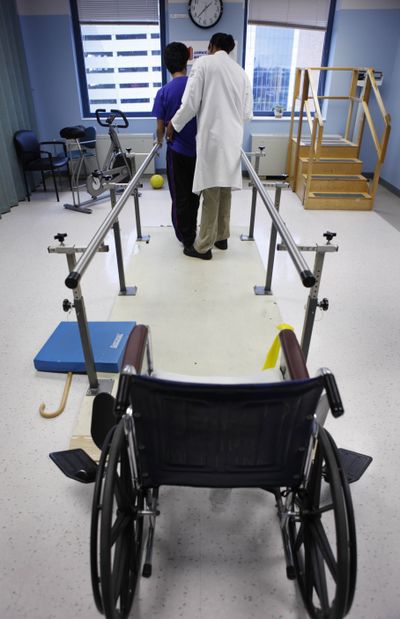 A patient, left, participates in rehabilitation in the Traumatic Brain Injury Unit at Jamaica Hospital in New York.  (Associated Press / The Spokesman-Review)