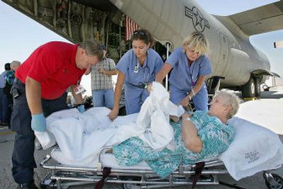 
Hurricane Katrina refugee Margaret Lee, of Bay St. Louis, Miss., is helped onto a gurney after being brought off a C-130 Idaho Air National Guard transport plane by medical personnel, from left, Stacey Fogg, Chelsa Garcia and Linda Stephenson, Tuesday at Gowen Field in Boise. Lee was one of six people brought to Idaho from the hurricane zone on Tuesday for medical care and housing.
 (Associated Press / The Spokesman-Review)