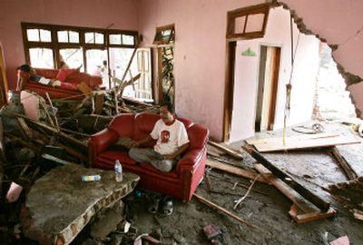
An Indonesian man sits in the living room of a beachfront house destroyed by Monday's tsunami  in Pangandaran, Indonesia. 
 (Associated Press / The Spokesman-Review)