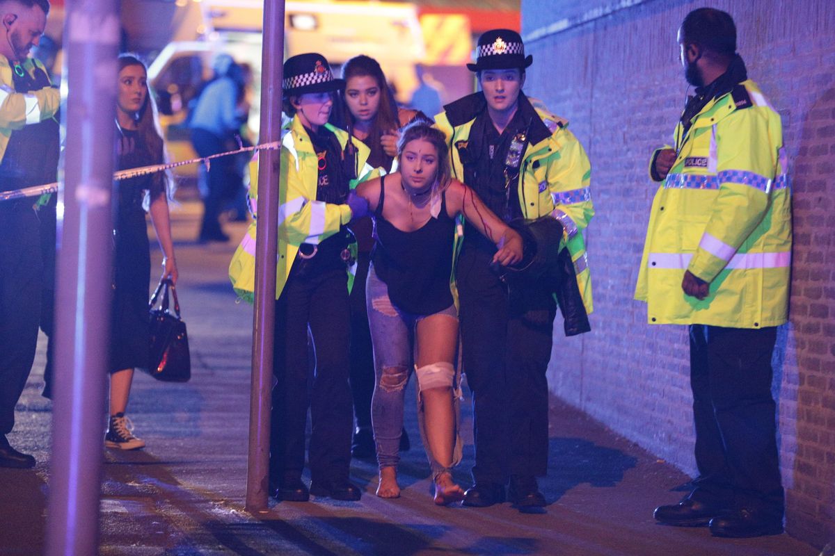 Manchester, UK. Police and other emergency services are seen near the Manchester Arena after reports of an explosion. Police have confirmed they are responding to an incident during an Ariana Grande concert at the venue. Reported Explosion at Manchester Arena, UK - 22 May 2017 (Goodman/LNP/REX/Shutterstock / Associated Press)