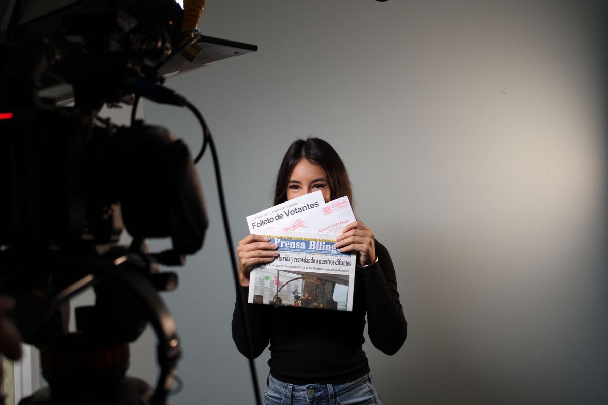 Jacquelyn Garcia-Angulo, community organizer of Mujeres in Action, held up a translated voter pamphlet Wednesday morning, Oct. 16, while filming an informative video on the importance of voting. This is part of their initiative to make voter information more accessible and combat voter misinformation.  (Monica Carrillo-Casas/The Spokesman-Review)