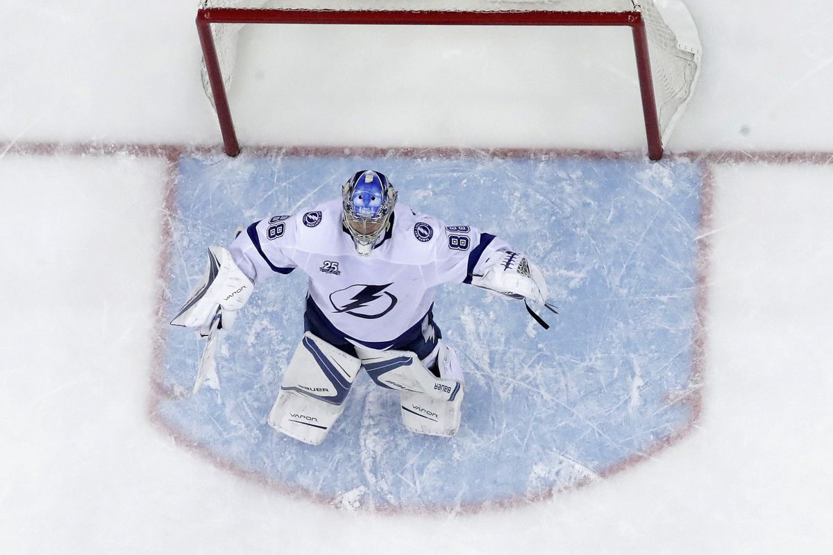 Tampa Bay Lightning goaltender Andrei Vasilevskiy, of Russia, celebrates as teammate Nikita Kucherov, not pictured, also of Russia, scored an empty-net during the third period of Game 4 of an NHL first-round hockey playoff series against the New Jersey Devils, Wednesday, April 18, 2018, in Newark, N.J. The Lightning won 3-1. (Julio Cortez / Associated Press)