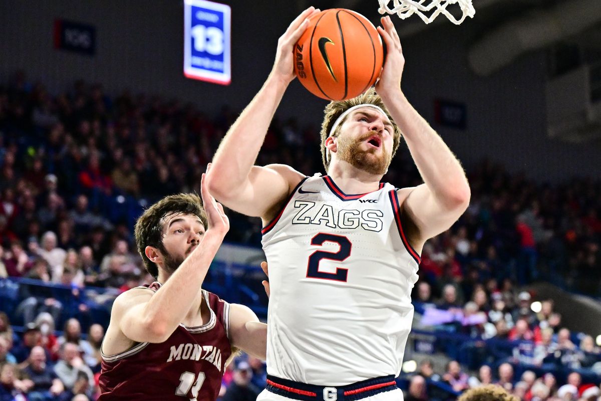 Gonzaga Bulldogs forward Drew Timme (2) moves past Montana Grizzlies forward Josh Bannan (13) during the first half of a college basketball game on Tuesday, Dec. 20, 2022, at McCarthey Athletic Center in Spokane, Wash.  (Tyler Tjomsland/The Spokesman-Review)