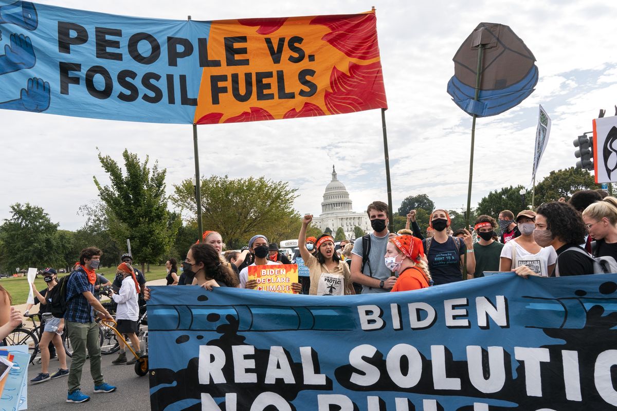 Climate and indigenous activists walk into the intersection of Pennsylvania and 3rd St NW during a climate change protest, Friday, Oct. 15, 2021, by the U.S. Capitol in Washington.  (Jacquelyn Martin)