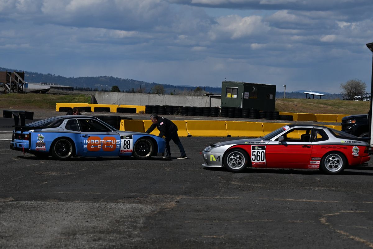 Indomitus Racing team pulls their heavily modified Porsche 944’s out of their trailer on Friday, May 13, 2022, at Qlispé Raceway Park in Airway Heights, Wash.  (Tyler Tjomsland/The Spokesman-Review)