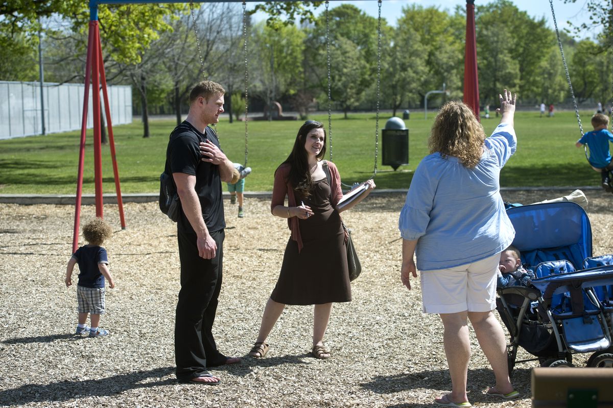 GU students Jake Wood and Emily Fulp chat April 21 with Logan area resident Alicia Davies in Mission Park. (Dan Pelle)