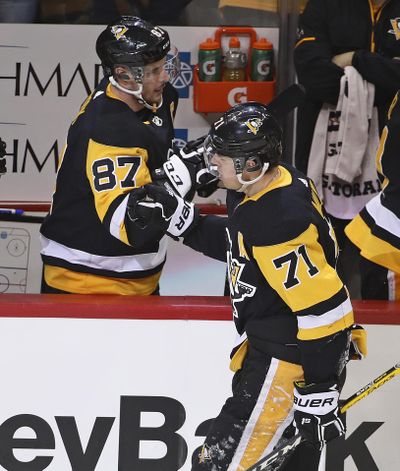 Pittsburgh Penguins’ Evgeni Malkin (71) celebrates with Sidney Crosby (87) after scoring in the first period of the team’s NHL hockey game against the Montreal Canadiens in Pittsburgh, Wednesday, March 21, 2018. (Gene J. Puskar / Associated Press)