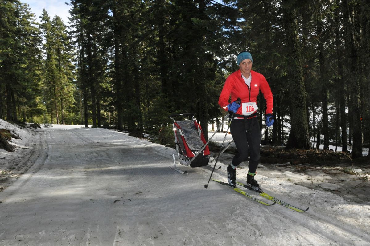 Haley Cooper-Scott, a triathlete who's used to being ahead in the pack, towed her infant baby in the Langlauf cross-country ski race at Mount Spokane on Feb. 8, 2015.  "This is a reality check," she said.  Cooper-Scott is skiing by the one major icy spot that formed on the 10K course after days of record-warm temperatures and rain.  (Rich Landers)