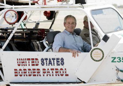 
President Bush rides a dune buggy driven by Rocky Kittle as he tours the Yuma Sector Border along the U.S.-Mexico border on Thursday in San Luis, Ariz. 
 (Associated Press / The Spokesman-Review)