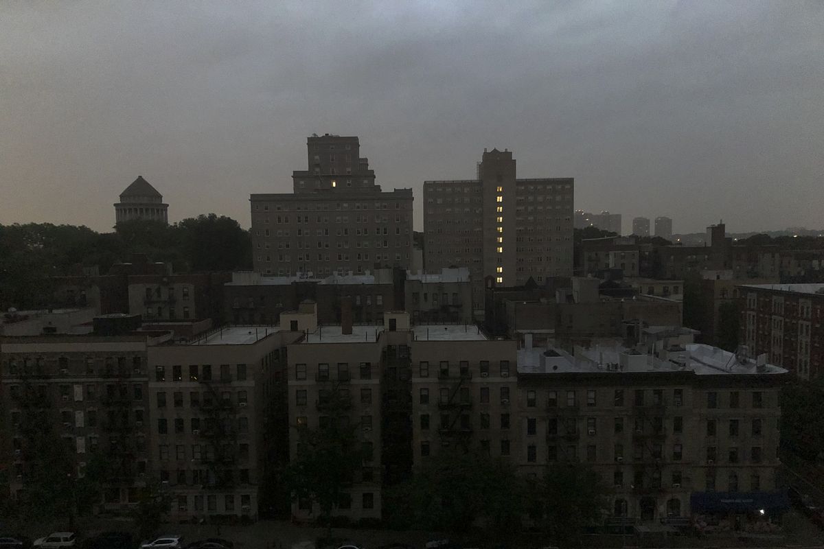 Buildings in Harlem sit dark during a power outage early, Friday, Aug. 7, 2020, in New York. A power outage cast darkness across dozens of blocks in New York City as many people in the city were still without electricity in the aftermath of Tropical Storm Isaias. Con Edison said that a problem with its transmission system "caused three networks in Manhattan to lose their electric supply," just after 5 a.m.  (Candice Choi)