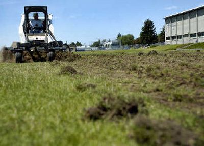
Dean Henry of Pauletto Trucking and Excavation, Inc., mixes sod with soil on the Gonzaga Prep High School football field on Tuesday. 
 (Holly Pickett / The Spokesman-Review)