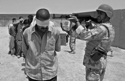 Detained suspected insurgents are guarded at an Iraqi security forces base in Baqouba, northeast of Baghdad, on Tuesday.
(Associated Press / The Spokesman-Review)
