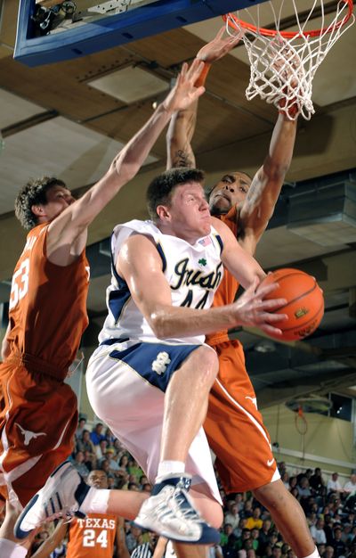 Notre Dame’s Luke Harangody drives between Texas’ Clint Chapman, left, and Gary Johnson during the first half of their game in the Maui Invitational. (Associated Press / The Spokesman-Review)
