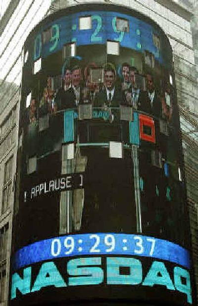 
The faces of Google and Nasdaq executives appear in a video image Thursday morning in Times Square.
 (Associated Press / The Spokesman-Review)