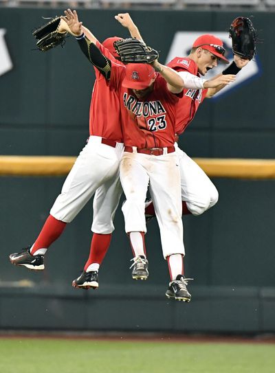 Arizona's Justin Behnke, left, Zach Gibbons and Jared Oliva, right, celebrate the Wildcats’ shutout of UC Santa Barbara. (Ted Kirk / Associated Press)