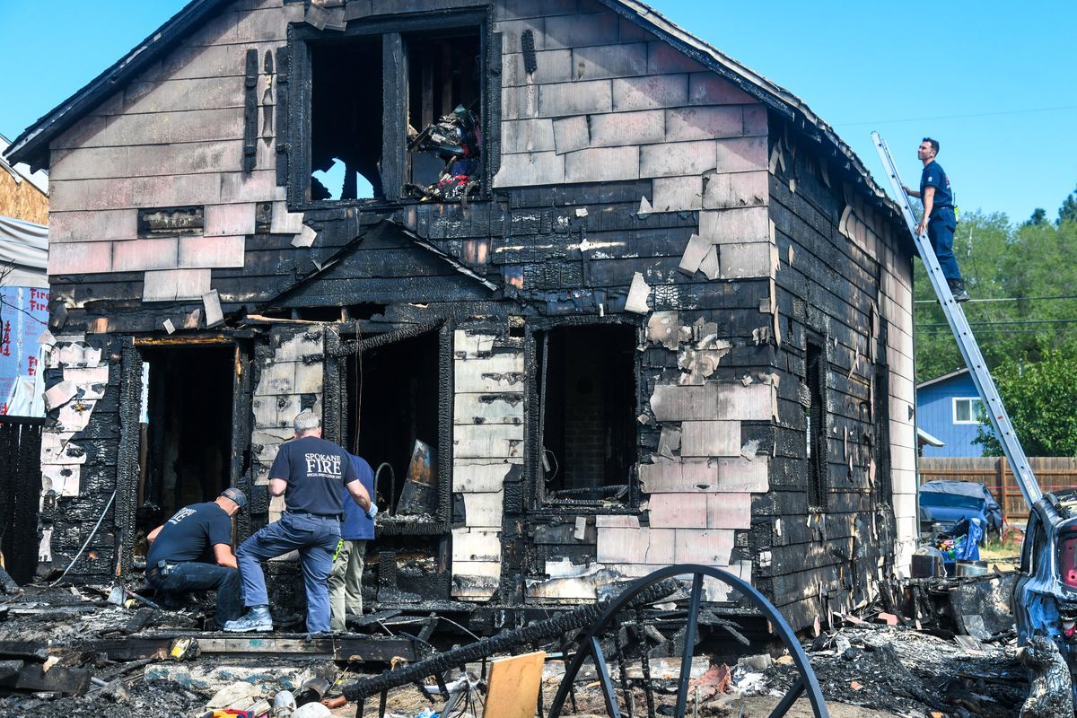 Spokane Fire Department inspectors and firefighters were on the scene Monday, morning, Aug. 23, 2021, searching for evidence in the aftermath of a fatal fire at 1307 E. Nebraska Avenue. Three people have died in the blaze that broke out on Sunday afternoon.  (DAN PELLE/THE SPOKESMAN-REVIEW)