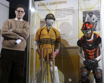 In this April 7, 2011 photo, senior curator Tom Shieber poses with uniforms worn by a cricket wicket-keeper, left, and a baseball catcher at the Baseball Hall of Fame in Cooperstown, N.Y. Baseball has never been as big as soccer or cricket in Britain, but it has deep roots – by some measure, in fact, deeper than its storied history in the United States. The arrival of the New York Yankees and Boston Red Sox in London for Major League Baseball’s first games in Europe this weekend is being treated as a festival of Americana, but it may be that what has come to be regarded as America’s game in fact started in England, before the revolution – or insurrection, depending on the teller – separated the colonies from the mother country. (Mike Groll / Associated Press)