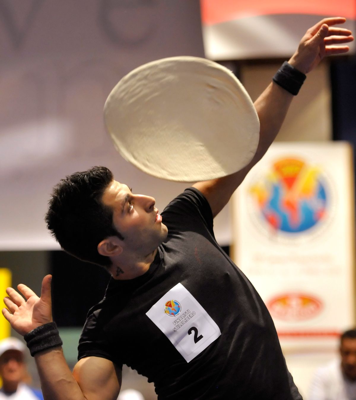 Italy’s Alessandro Colluccino performs with dough during an acrobatic pizza event, part of the Pizza World Championships in Parma, Italy, on April 17, 2013. The acrobatics of pizza dough throwing are optional for beginner cooks, but learning how dough feels is a basic cooking skill.  (Associated Press)