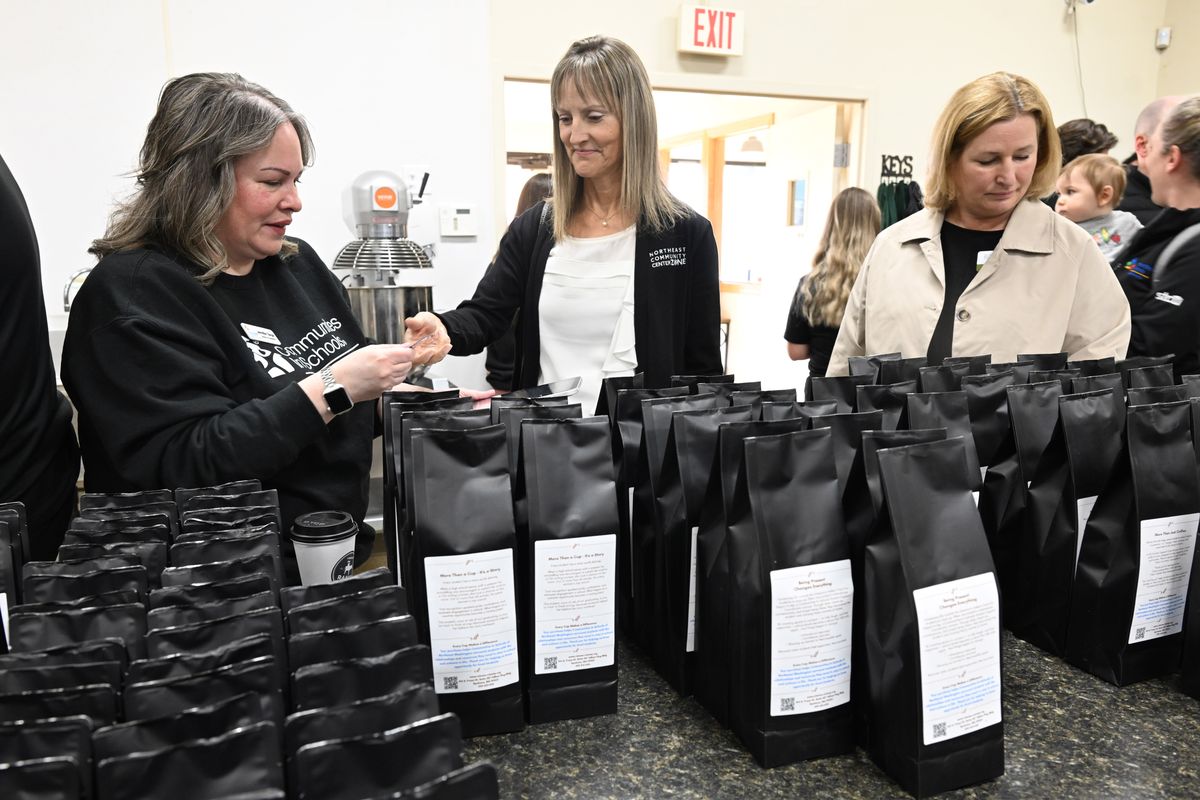 Jene Ray, center, purchases some of the new coffee blends made by LaShaw Ranch Roasters from Jennifer Siegel, left, while Yvonne Trudeau shops at right at a fundraiser for Communities in Schools of Northeast Washington. The blends were introduced at a kick-off event Friday at Spokane Food and Events, a commercial kitchen at 723 N. Crestline. (Jesse Tinsley/THE SPOKESMAN-REVIEW)