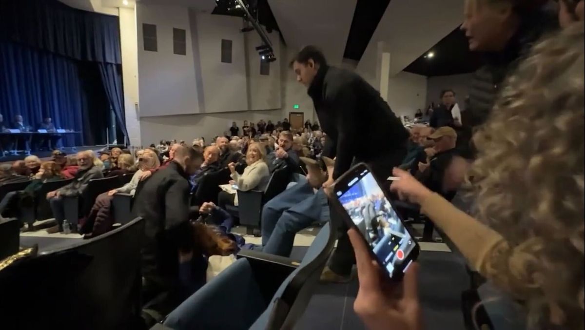 Teresa Borrenpohl is dragged from a Coeur d’Alene town hall by two men in plainclothes in February 2025. (Screen capture)
